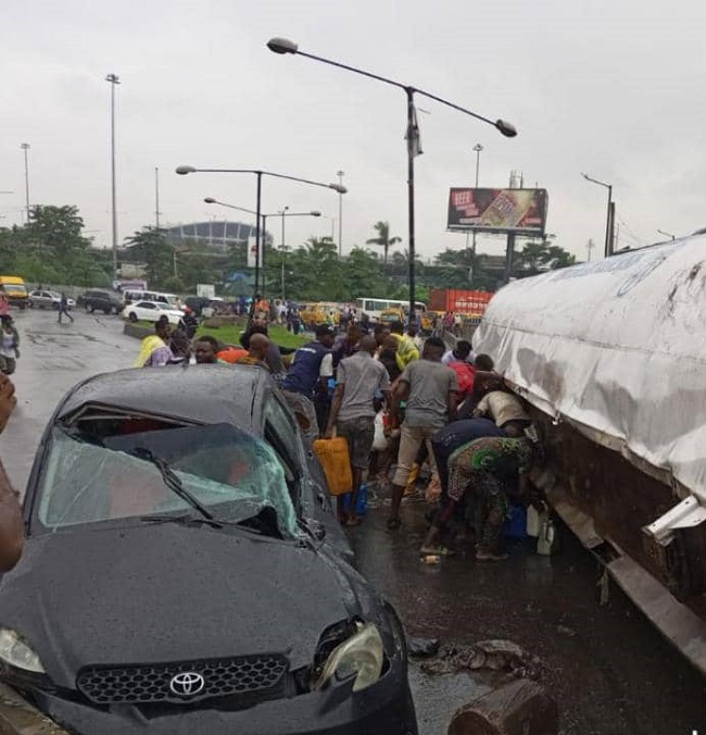 Lagos residents scoop petrol as tanker falls on Costain Bridge
